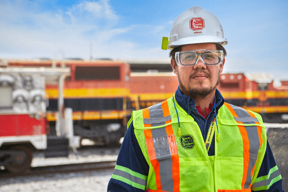 An employee wearing safety equipment working on a railway.